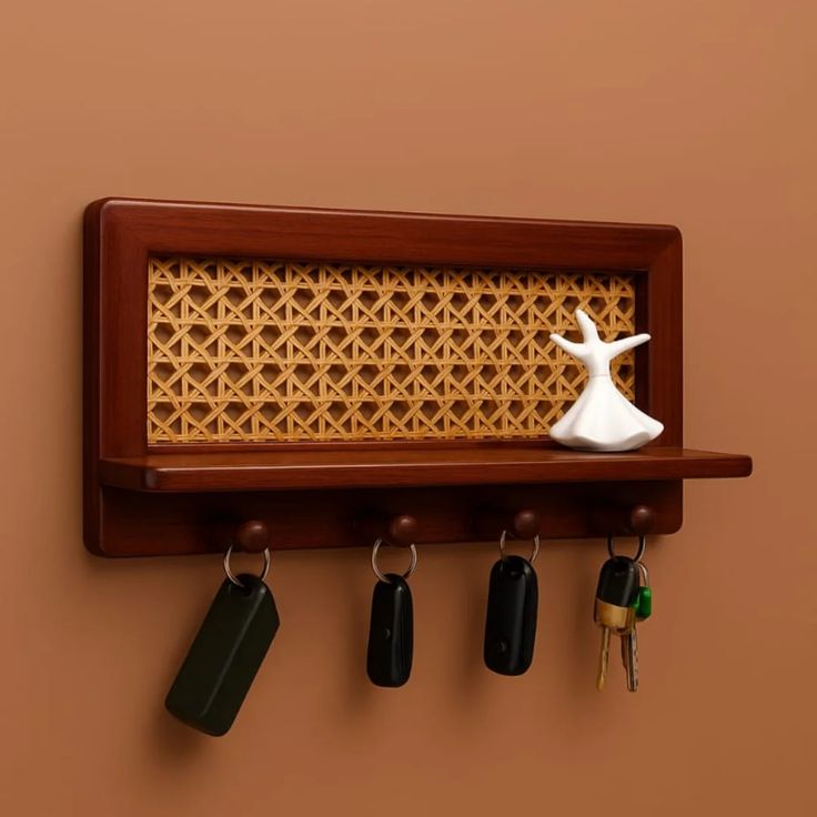 Oak key holder shelf with mail slot and 3 bronze hooks styled with small terracotta vase and carnations on wall