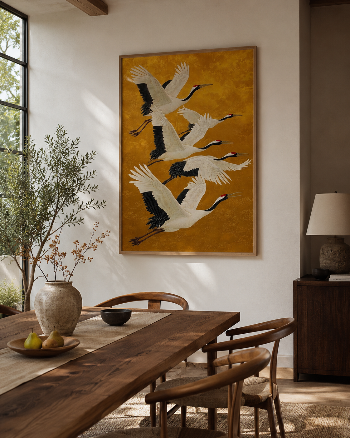 Flying cranes canvas above rustic wood dining table with olive branches in Japandi dining room