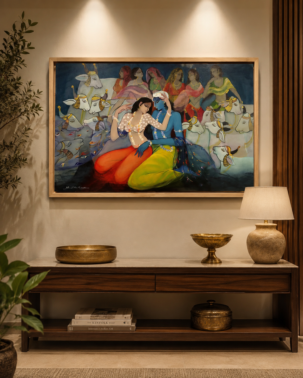 Radha Krishna canvas above dark console table with brass bowls and lamp in warm Indian contemporary entryway