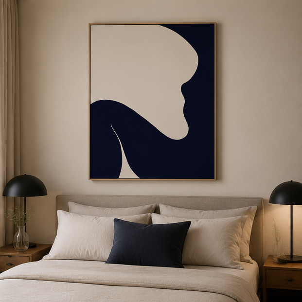 Navy cream abstract painting above linen bed with dark navy cushion and black dome lamps in serene bedroom